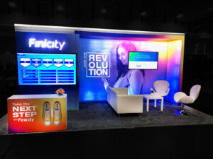 Finicity 10×20 inline booth with strategic exhibit lighting at MBA